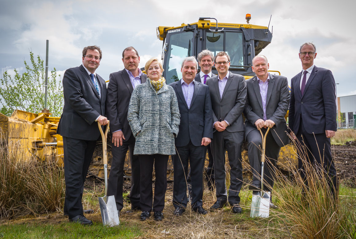 wcctv-rda-rmbc Image of dignitaries in front of a stationary bulldozer at Kingsway Business Park